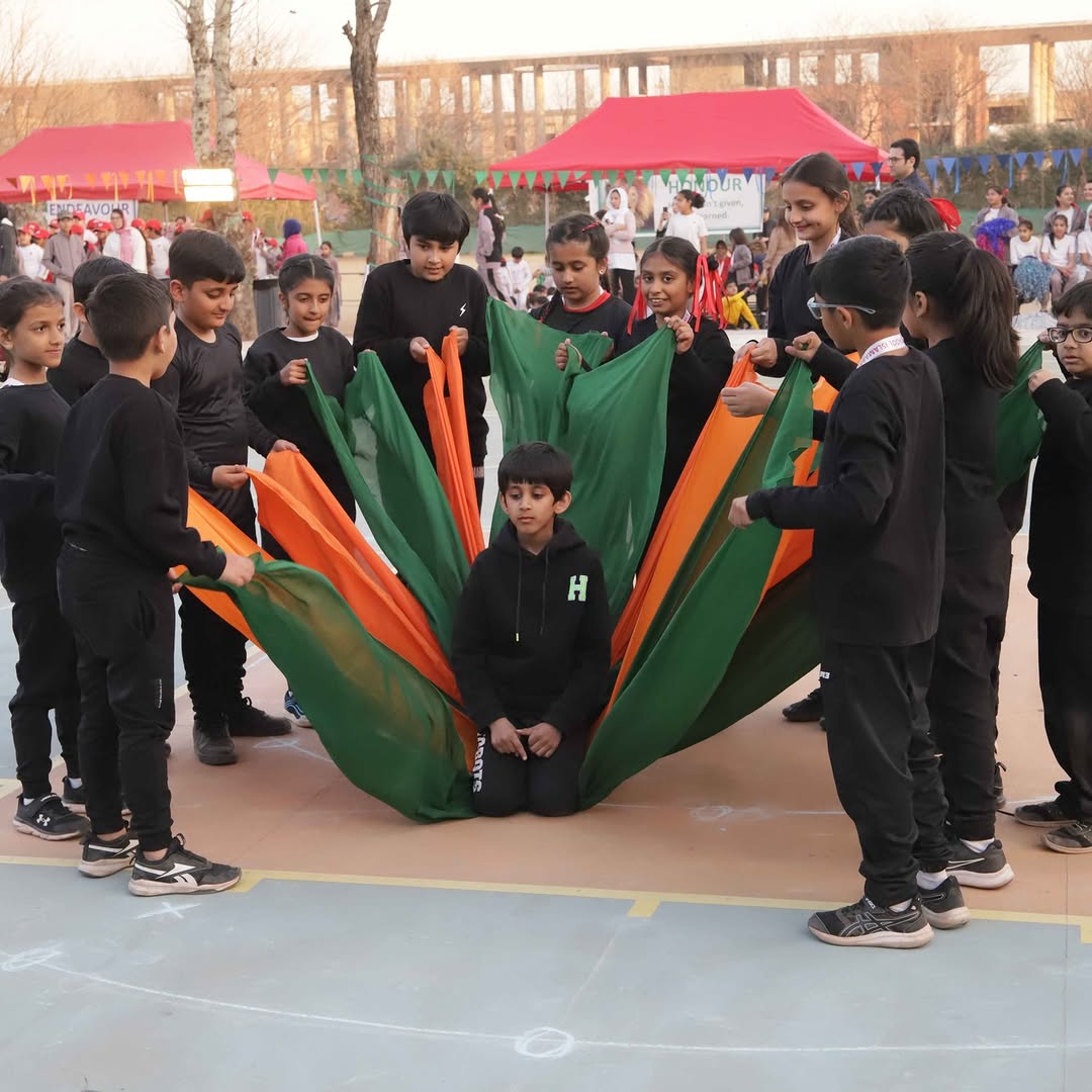 Junior students in a parachute game at the Sports Meet