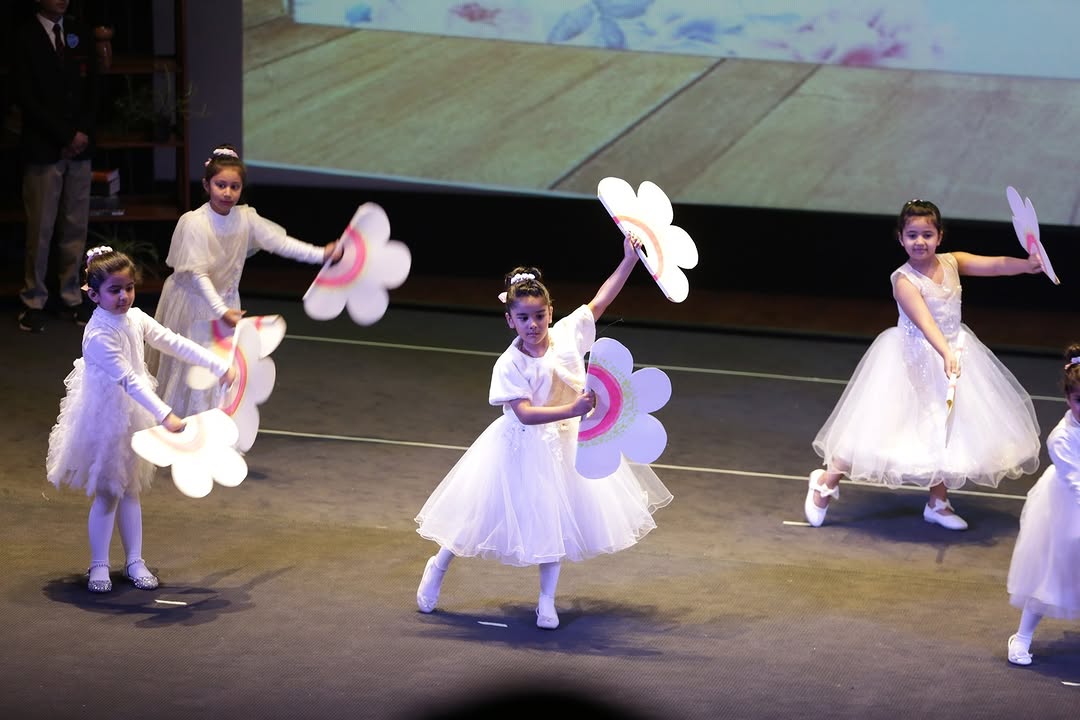 Junior students performing a dance on stage