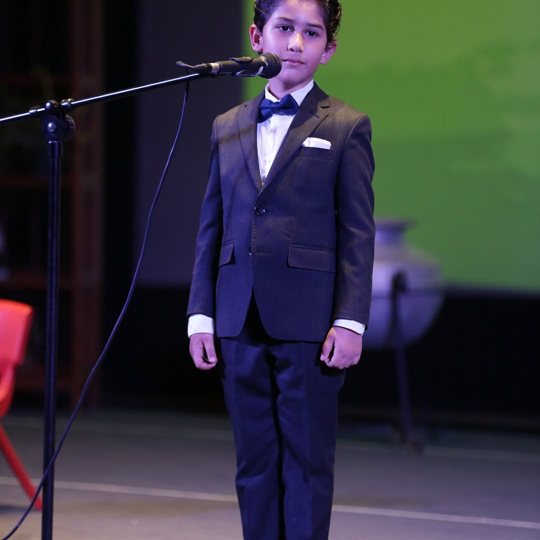 PSI student speaking on stage
